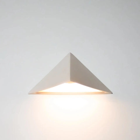 The Modern USA-Made Sumatra Downlight Sconce by A19 Artisan Lighting is handcrafted in California, featuring a minimalist triangular design with energy-efficient LED light that creates a gentle glow—ideal for modern spaces.