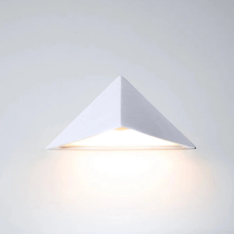 The Modern USA-Made Wall Lighting – Sumatra Downlight Sconce by A19 Artisan Lighting casts an energy-efficient LED glow downward, creating a soft, warm ambiance against a light-colored wall. Handcrafted in California.