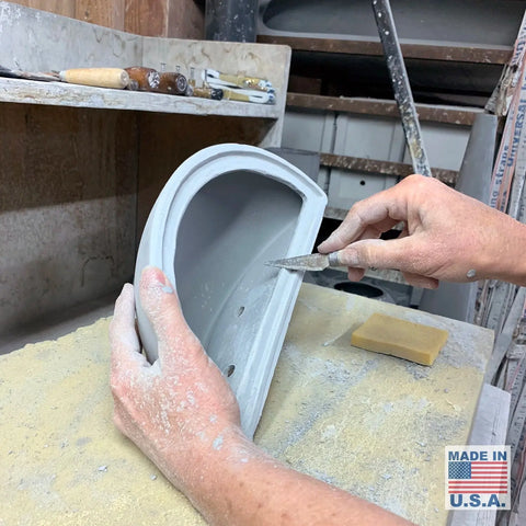 An artisan shapes the Modern USA-Made Wall Lighting – Thera Sconce by A19 Artisan Lighting in a California workshop, with tools nearby and a Made in U.S.A. label highlighting its handcrafted, customizable American quality.