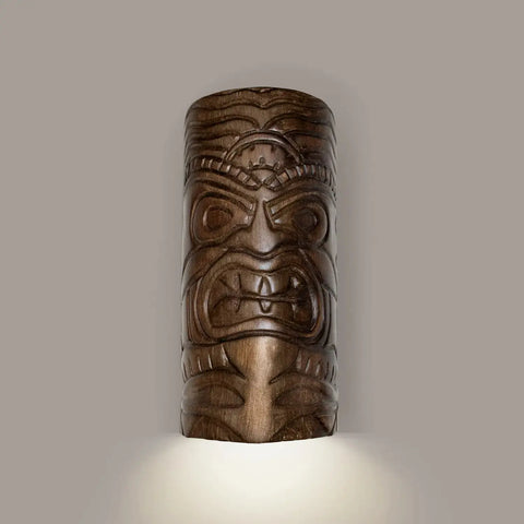 The Modern USA-Made Tiki Downlight Sconce by A19 Artisan Lighting features a bold Tiki face design, handcrafted in California, and casts a downward light against a plain light gray background.