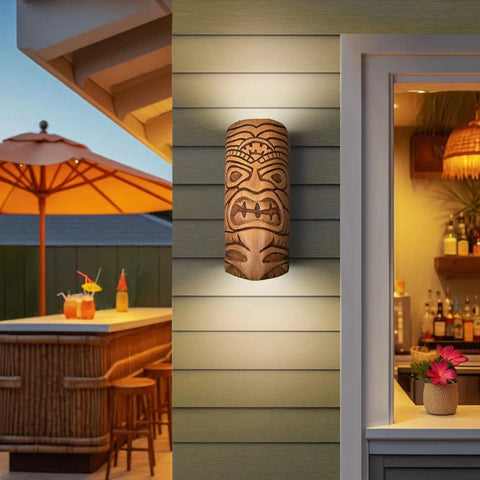 The Modern USA-Made Wall Lighting – Tiki Sconce by A19 Artisan Lighting, handcrafted in California, casts warm light on a tiki bar’s exterior wall, with tropical drinks, bar stools, bottles, and flowers visible nearby.