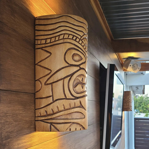 The Modern USA-Made Tiki Sconce by A19 Artisan Lighting, handcrafted in California with tribal-inspired carvings, adds warm LED smart lighting to any modern indoor or outdoor space.