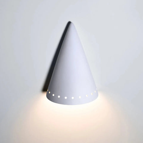 Handcrafted in California by A19 Artisan Lighting, the Zealandia Downlight Sconce features a white, cone-shaped ceramic design with circular cutouts and is compatible with LED smart bulbs for stylish, efficient wall lighting.