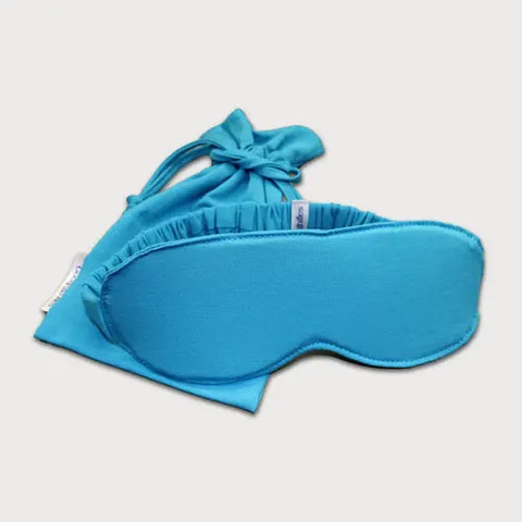 The Goodnighties Sleep Mask With Pouch is a bright blue, handcrafted set made from soft material, shown on a white background.