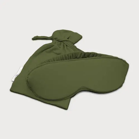 The Goodnighties Sleep Mask With Pouch, made in the USA, features an olive green eye mask with an elastic band and comes with a matching drawstring pouch, both shown against a white background.