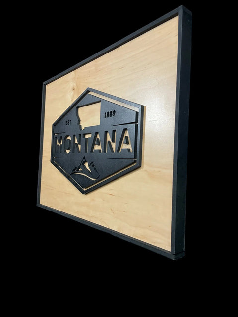 The B. James Design & Woodwork Framed Montana Emblem Sign features a black frame, mountain design, MONTANA EST 1889 text, and a birch background for rustic style.
