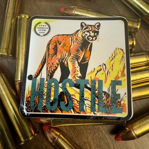 The American Lictor Sticker: Mountain Lion - Hostile features an illustrated mountain lion, bold HOSTILE text, and copper bullets—a perfect addition to your tactical gear or stealth patch collection.