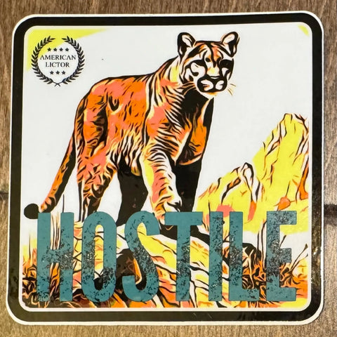 The Sticker: Mountain Lion - Hostile by American Lictor features a stylized cougar on rocky terrain, with HOSTILE in bold at the bottom and a small American Lictor emblem in the top left corner.