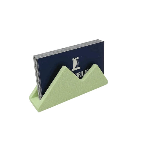 The Mountain Silhouette Design Business Card Holder Display by Chatelet Manufacturing stylishly displays your cards and decorates office desks, adding a unique touch to any workspace.