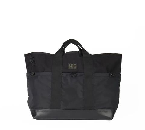 The MIS Multi Pocket Tote Bag - Black features durable Cordura nylon, a rectangular shape, short handles, reinforced corners, front pockets, and the MIS logo on the front. Made in the USA and designed for everyday use.