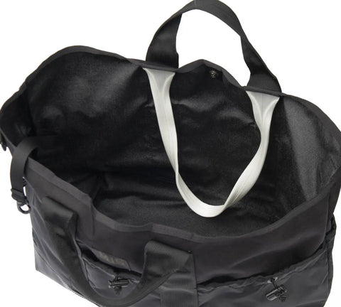 The MIS Multi Pocket Tote Bag - Black is a large, USA-made Cordura nylon tote with an open top, roomy interior, two black handles, a white inner strap, and water resistance—ideal for everyday style and function.