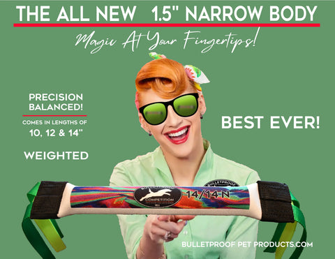 A smiling red-haired woman in green sunglasses and shirt holds the New Narrow Dock Diving Bumper Tug by Bulletproof Pet Products—Electric Candy for Smaller Dogs. 1.5” wide, weighted, precision balanced, in 10”, 12”, or 14” lengths—the best competition toy!.