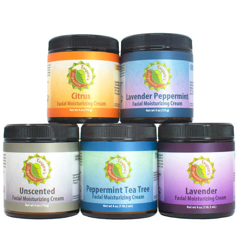 Five jars of Taspens Organics Facial Moisturizing Cream are stacked in a pyramid, each with a vibrant label: Citrus, Lavender Peppermint, Unscented, Peppermint Tea Tree, and Lavender. Experience this American-made skincare collection.