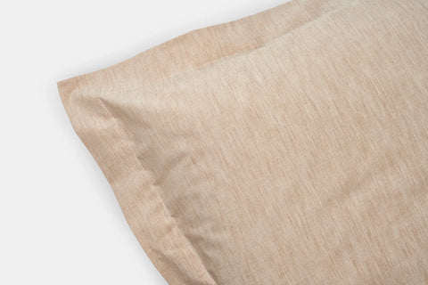Close-up of the American Blossom Linens Natural Colored Cotton Duvet Cover Set, crafted from heirloom cotton with a subtle textured pattern, shown on a white background.
