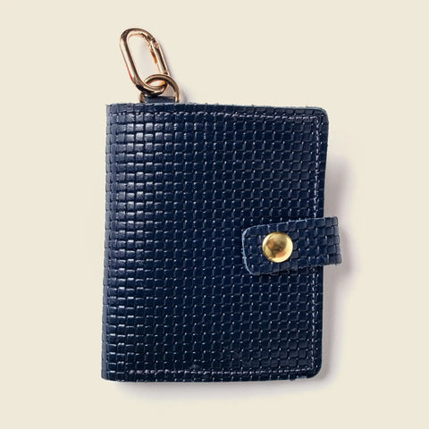The CASUPO Wallet With Snap and Key Ring - Navy Limited Edition is a handcrafted sustainable leather wallet in dark blue, featuring a snap closure and gold keychain clip, shown on a light beige background.