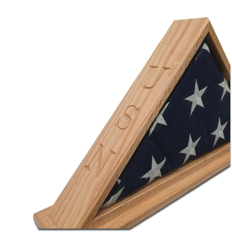 A folded American flag with white stars on blue is showcased in the Legacies of America Woodworking Company Navy Veteran USN Oak Burial Flag Display Case (5 x 9.5 flag).