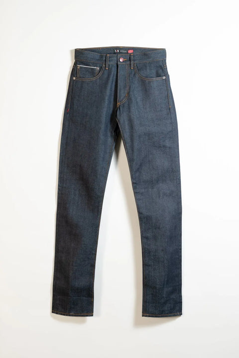 The Marc Nelson The Nelson Cone Mills Selvedge Denim jeans feature dark blue Cone Mills denim, a classic five-pocket design, straight legs, and visible copper stitching, shown laid flat on a white background.
