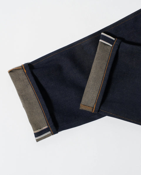 Close-up of the cuffs on Marc Nelsons Nelson Cone Mills Selvedge Denim Jeans – 10.5 oz USA-made, showing the contrasting inner fabric and signature white and colored selvedge edge.