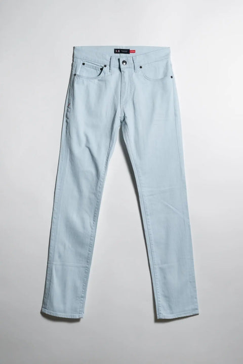 The Marc Nelson The Nelson Ultra Light Wash Denim jeans are shown laid flat on a white background, front side up, featuring a classic 5-pocket design with black button, rivets, and visible pockets in light blue ultra-light wash.