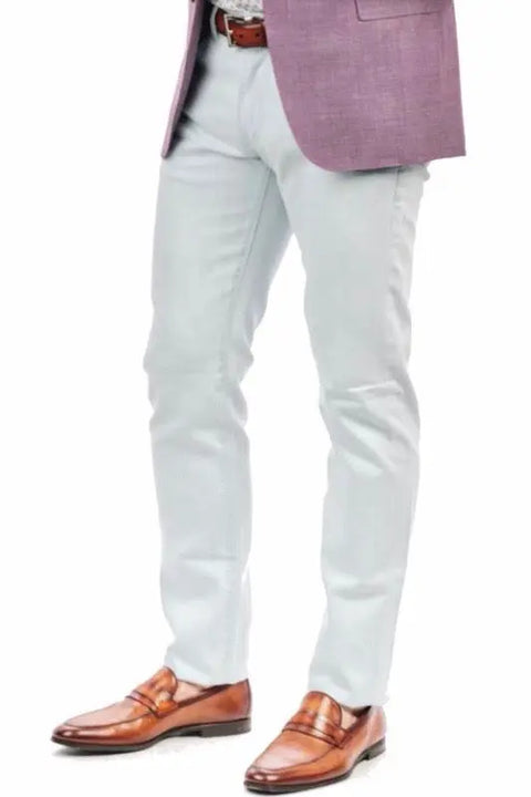 A person is wearing The Nelson Ultra Light Wash Denim by Marc Nelson, styled with a brown belt, mauve blazer, and brown leather loafers, standing against a white background. Their upper body is only partially visible.