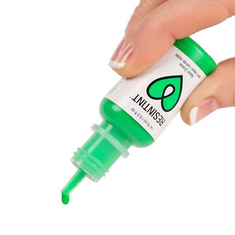 A hand holds a small green bottle of ArtResin ResinTint Neons—4 Colors, dispensing vivid green tint with a pointed nozzle. The label features a green teardrop and RESIN TINT, perfect for adding vibrant color to your resin projects.
