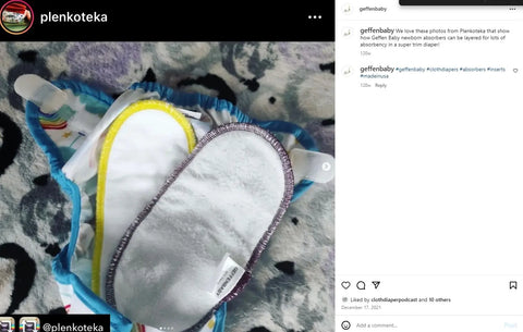 A close-up of an open cloth diaper with two Geffenbaby Newborn Quick Absorbers Diaper Inserts, one trimmed in yellow and the other in purple, shown on a soft, patterned surface.