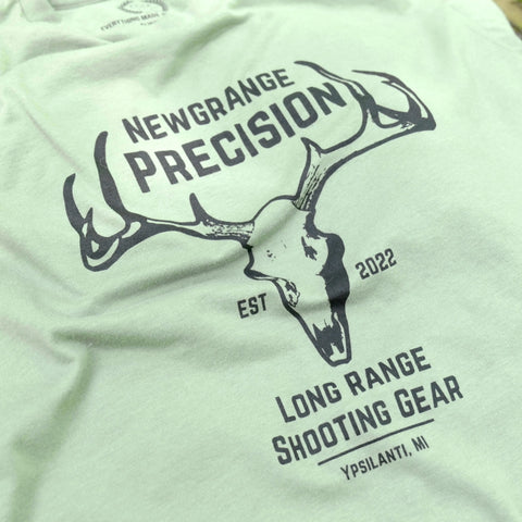 The Collab Tee: Newgrange Logo by American Lictor is a light green, compacted ring-spun cotton T-shirt with a deer antlers and skull graphic and Newgrange Precision, Est 2022, Long Range Shooting Gear, Ypsilanti, MI text. Check our size guide.
