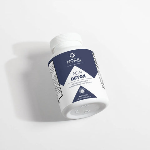 A white bottle labeled “Acai Detox” by Norri Nutrition, featuring a blue and white design and containing 60 capsules for detox and weight loss support, rests on a white surface with a subtle shadow.