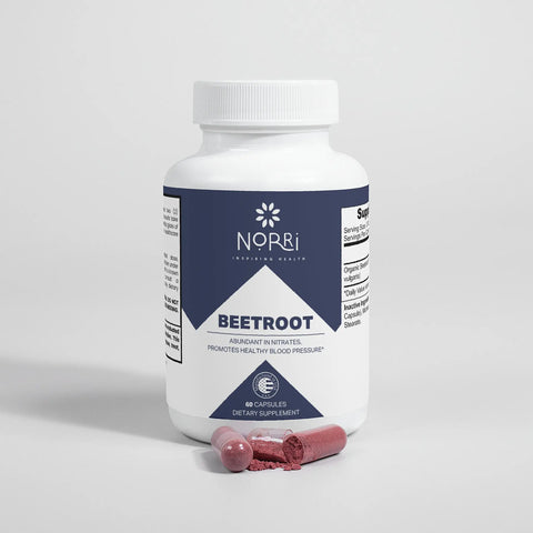 A white bottle labeled Norri Nutrition Beetroot dietary supplement with blue accents sits on a white surface. In front, two opened red capsules and beetroot powder—known for supporting nitric oxide and heart wellness—are displayed.