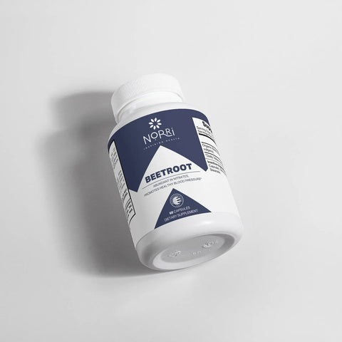 A white plastic bottle of Norri Nutrition Beetroot lies on its side. The navy blue and white label notes it contains 60 capsules, formulated to support blood pressure, stamina, and cardiovascular wellness.