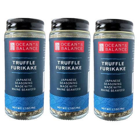 Three jars of Oceans Balance Truffle Furikake, a vegan seaweed seasoning, are displayed side by side against a black background.
