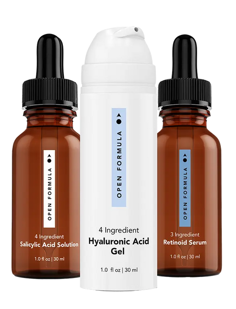 The Blemish Control Superset from Open Formula includes a salicylic acid solution for blemish-prone skin, a retinoid serum in a brown dropper bottle, and a hydrating hyaluronic acid gel in a white pump bottle.