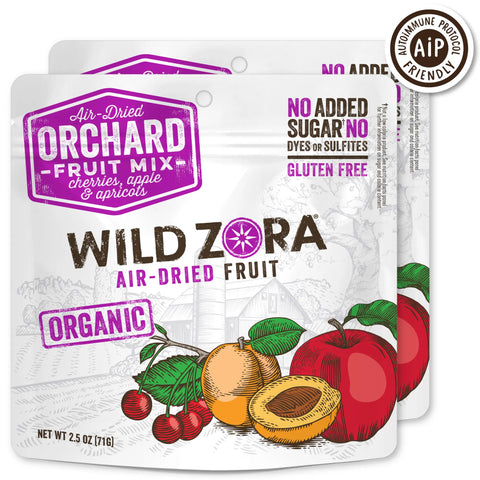 Wild Zora Fruits - Orchard Air-Dried Mix With Cherries, Apples & Apricots 2-Pack features organic ingredients. The packaging showcases No Added Sugar, Gluten Free, and AIP Friendly claims with illustrated fruits on the front.