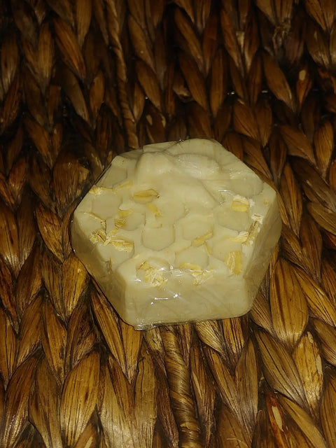 Bathsheba Body Works’ Body Butter Scrub - Country Butter is a translucent, hexagonal exfoliating soap with soothing oats, reminiscent of honeycomb—perfect for gentle care of sensitive skin.