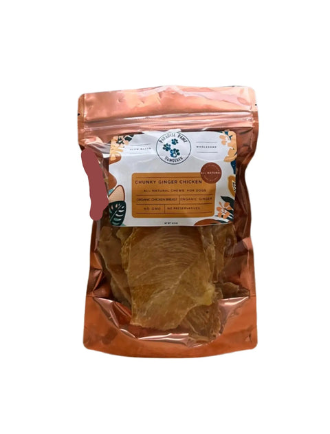 A resealable bag of Dogtown Bakery’s Chunky Ginger Chicken treats features a floral label and transparent window, highlighting organic dog treats made with natural ingredients—free from GMOs and preservatives.