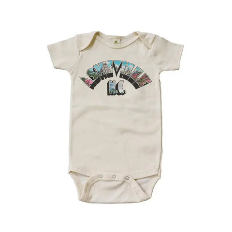 The Asheville Art Deco Arch Graphic Bodysuit by Spiritex | Sustainable Apparel is a cream organic cotton baby snappie with Asheville NC in colorful, postcard-style letters inspired by the Art Deco Arch and features easy snap closures.