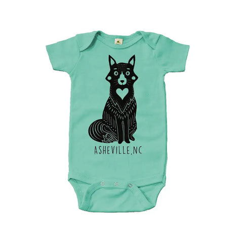 The Asheville Heart Fox Graphic Bodysuit by Spiritex | Sustainable Apparel is an organic cotton mint green baby bodysuit with a black heart fox design, “ASHEVILLE, NC” text, and made from soft fabric with non-toxic dyes.