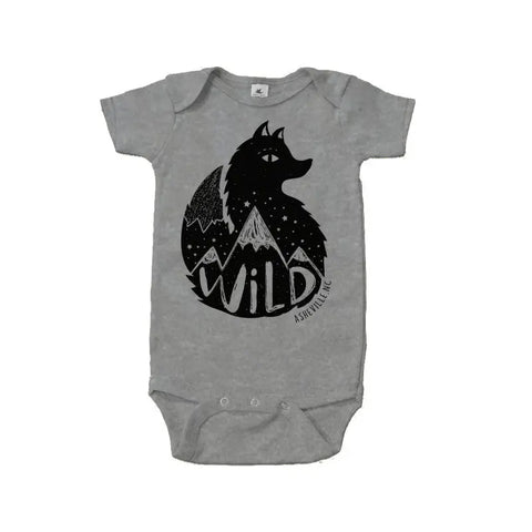 The Asheville Wild Fox Graphic Bodysuit by Spiritex | Sustainable Apparel is a gray organic cotton onesie for sensitive skin, featuring a black wolf, stars, mountains, and WILD in bold across the bottom.