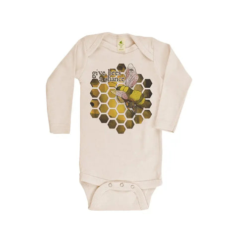 The Give Bees a Chance Long Sleeve Graphic Bodysuit by Spiritex | Sustainable Apparel is cream-colored with a honeycomb pattern, bee illustration, and give bees a chance text. Made from organic cotton, its gentle on sensitive skin.