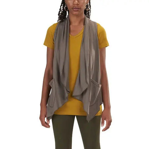 A person wears a yellow short-sleeve shirt, olive green pants, and the Spiritex Ultra Lightweight Draped Vest—an open-front gray vest with pockets—standing against a plain white background.