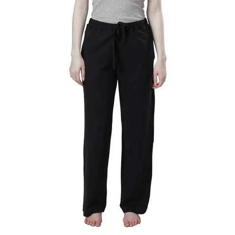 A person models the Spiritex | Sustainable Apparel Drawstring Lounge Pant, standing barefoot in a gray tank top against a plain white background.