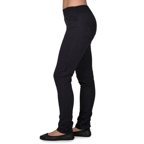 A person shown from shoulders down against a white background wears Spiritex | Sustainable Apparel Fleece Saratoga Pants and black ballet flats, standing sideways.