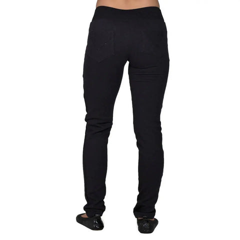 A person stands with their back to the camera, showing only the lower body in Spiritex | Sustainable Apparels Fleece Saratoga Pants and black shoes, set against a white background.