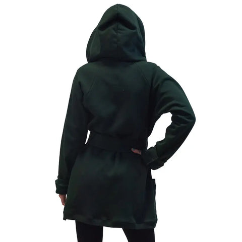 A person wearing the Spiritex Fleece Wrap Jacket in dark green, made from organic cotton fleece. Seen from the back with the hood up and one hand on their hip, this jacket features long sleeves and a relaxed fit.