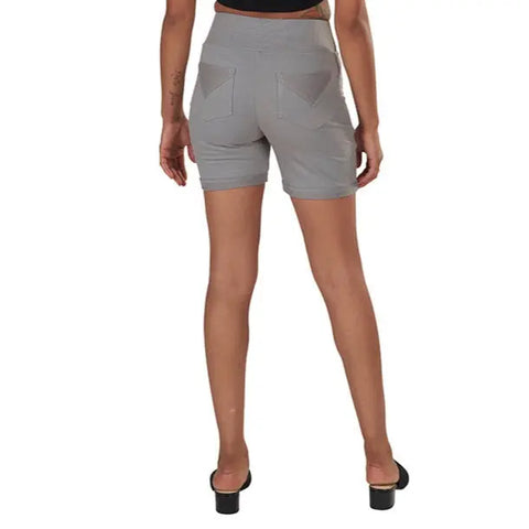 A person in a black top, Spiritex Saratoga Shorts—womens organic cotton shorts with back pockets—and black heeled sandals stands facing away from the camera against a white background.