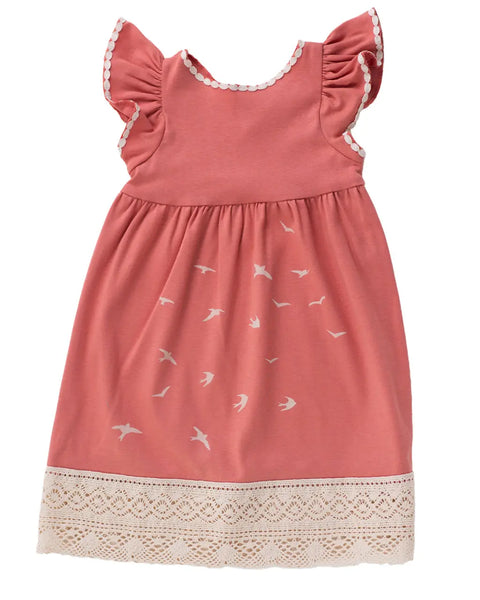 The Girls Bird Flock Dress by Spiritex | Sustainable Apparel is an adorable organic cotton dress in pink with white bird prints, ruffled sleeves, white trim, and cream lace—perfect for any occasion.