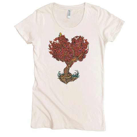 The Spiritex Heart Tree Graphic Tee is a cream-colored womens shirt made from organic cotton, featuring a heart tree with red leaves and a green bird perched on top, growing from floating soil.