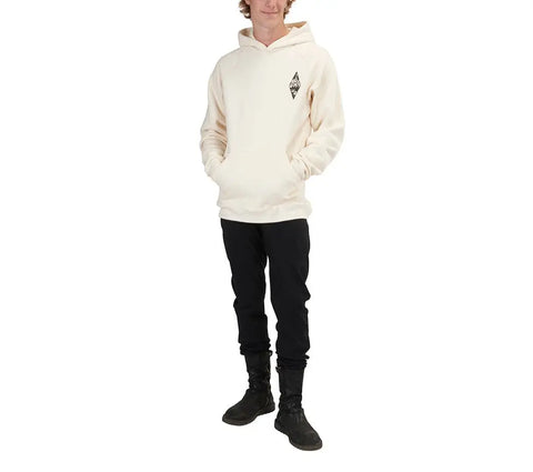 A person wears the Spiritex Graphic Heavyweight Fleece Hoodie | Mountain Scape, a cream organic cotton hoodie with a small black mountain graphic, paired with black pants and boots, standing against a white background.