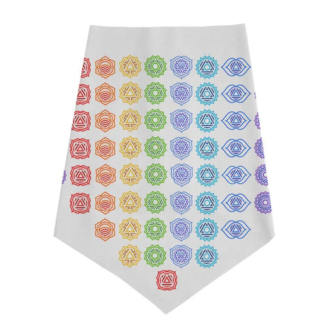 The Infinity Bandana by Spiritex | Sustainable Apparel is a white organic cotton bandana with colorful geometric mandala designs in a red-to-purple gradient, inspired by chakra symbols, and features a tapered end.