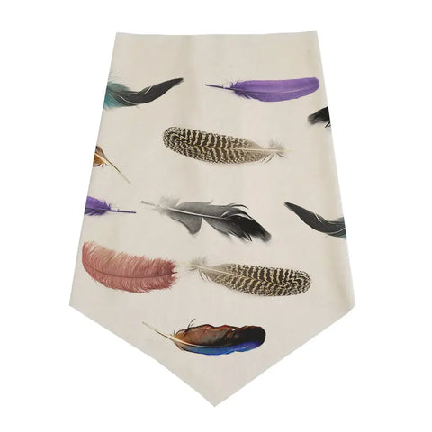 The Spiritex Infinity Bandana features an organic cotton fabric adorned with black, purple, brown, and speckled feather patterns for a unique, textured look.